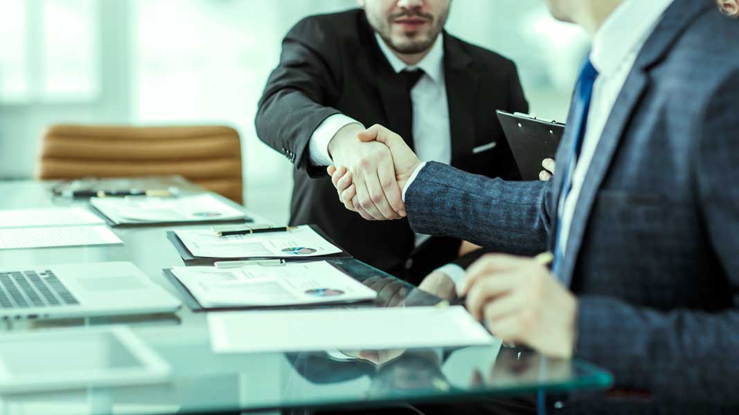handshake of two lawyers after discussing the terms of a financi Handshaking after loan has been approved