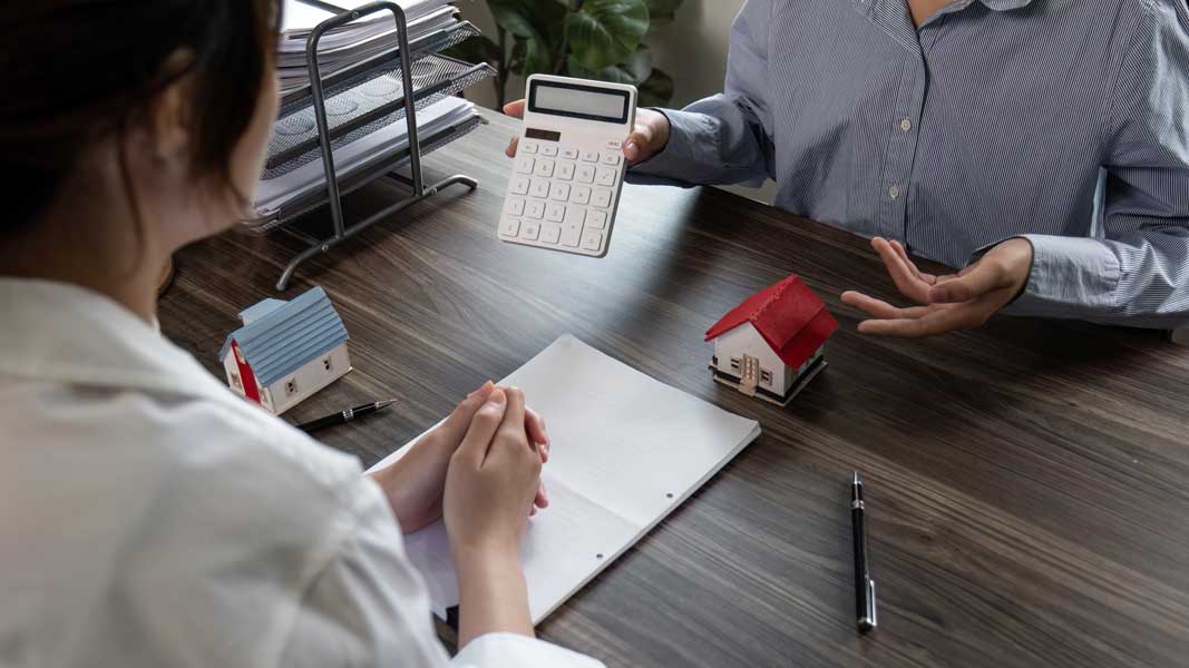 Village project representative and customer discuss purchase con Financing-documents-for-Hawaii-construction-project