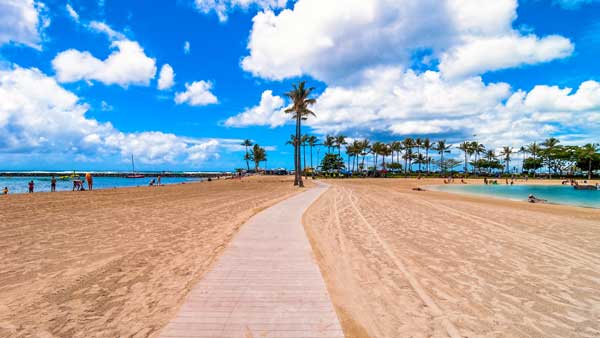 Waikiki shoreline with tourists in Honolulu Hawaii