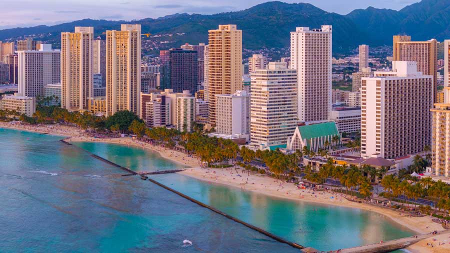 view of Waikiki beach and Honolulu skyline at sunset