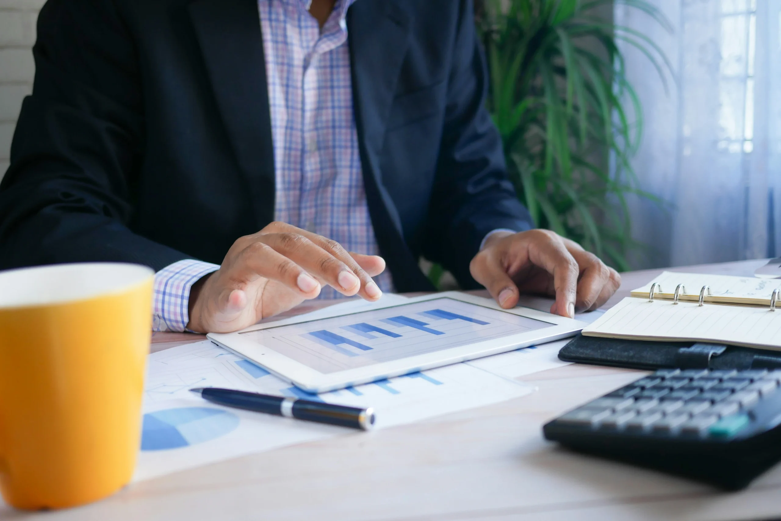 Photo of businessman using tablet to manage hard money loans for bad credit
