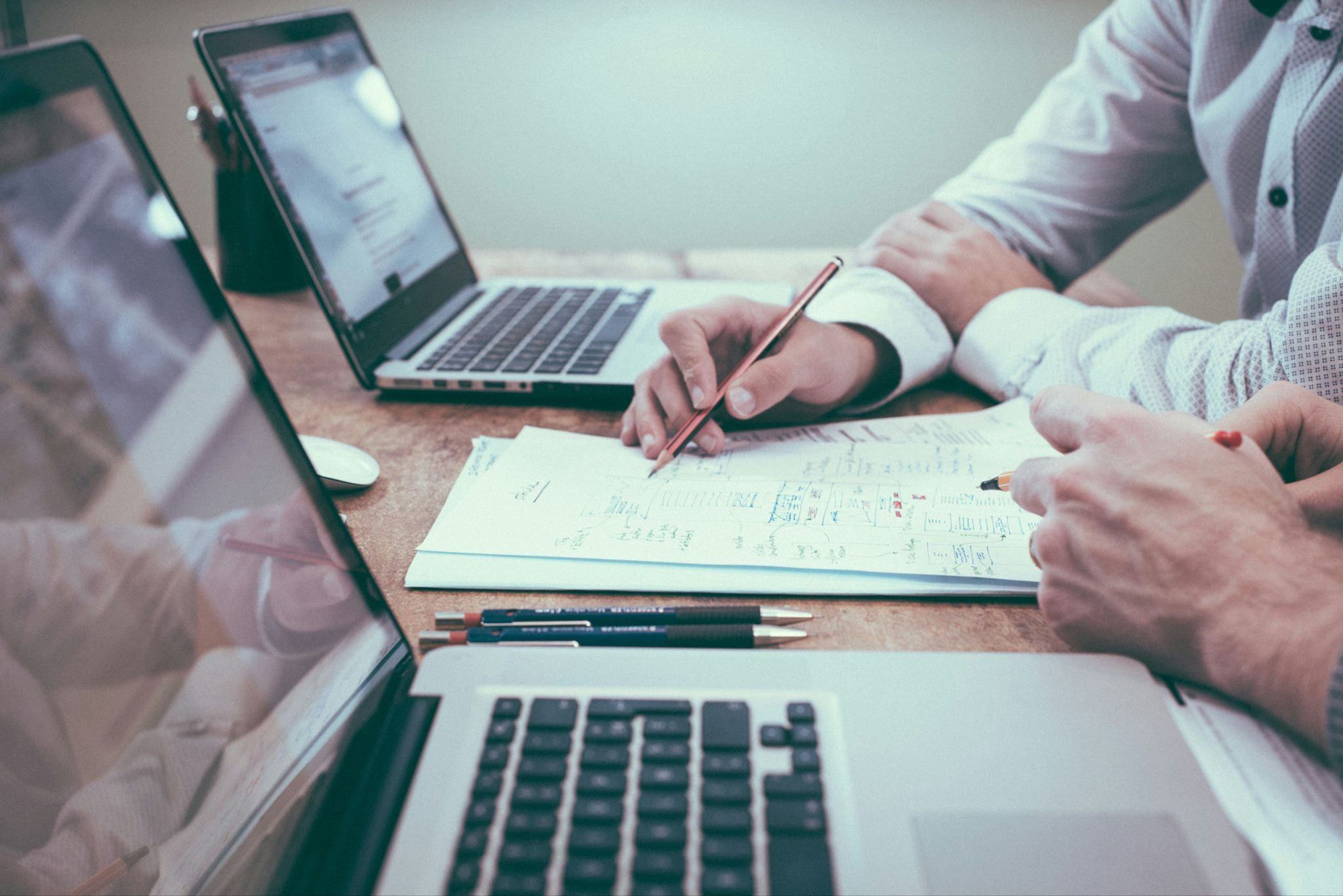 Photo of hands reviewing paperwork for a Hard Money Loan for Primary Residence at a desk
